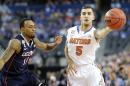 Florida guard Scottie Wilbekin (5) passes as Connecticut guard Ryan Boatright (11) defends during the first half of the NCAA Final Four tournament college basketball semifinal game Saturday, April 5, 2014, in Arlington, Texas. (AP Photo/Eric Gay)