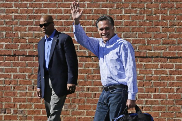 Republican presidential candidate and former Massachusetts Gov. Mitt Romney is accompanied by a U.S. Secret Service agent as he leaves debate preparation at a hotel in Columbus, Ohio, Saturday, Oct. 13, 2012. (AP Photo/Charles Dharapak)