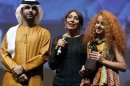 Director Haifaa Al-Mansour (C) and actress Waad Mohammed (R) at the Dubai International Film Festival, December 16, 2012