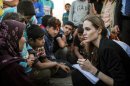 This June 18, 2013 photo released by the United Nations High Commissioner for Refugees (UNHCR) shows special envoy Angelina Jolie taking notes as she speaks with Syrian refugees in a Jordanian military camp based near the Syria-Jordan border. The Syrian civil war contributed to pushing the numbers of refugees and those displaced by conflict within their own nation to an 18-year high of 45.2 million worldwide by the end of 2012, the U.N. refugee agency said Wednesday, June 19. Most of the refugees in the world have fled from five war-affected countries: Afghanistan, Somalia, Iraq, Syria and Sudan. (AP Photo/United Nations High Commissioner for Refugees , O. Laban-Matte)