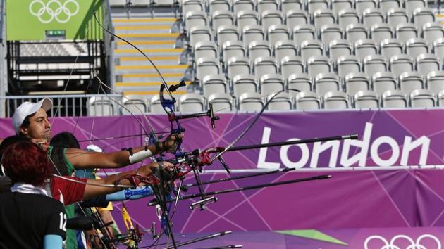 Athletes take aim during archery training ahead of the Olympic Games at the Lords Cricket Ground
