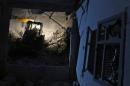 Civil defence members work at a site hit at night by an airstrike in Saraqeb, in rebel-held Idlib province