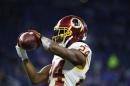 In this photo taken Oct. 23, 2016, Washington Redskins cornerback Josh Norman makes a catch during pre game of an NFL football game against the Detroit Lions in Detroit. Norman and Washington Redskins tight end Jordan Reed have been cleared to fly with the team to London for its game against the Cincinnati Bengals after dealing with concussions. (AP Photo/Paul Sancya)
