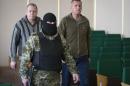 John Christensen, right, a senior Sgt. in the Danish army and his colleague, both members of a group of foreign military observers are escorted by a pro-Russian militant to attend a press conference in the city hall of Slovyansk, eastern Ukraine, Sunday, April 27, 2014. As Western governments vowed to impose more sanctions against Russia and its supporters in eastern Ukraine, a group of foreign military observers remained in captivity Saturday accused of being NATO spies by a pro-Russian insurgency. The German-led, eight-member team was traveling under the auspices of the Organization of Security and Cooperation in Europe when they were detained Friday. (AP Photo/Alexander Zemlianichenko)