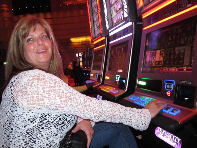 FILE - In this May 21, 2012 file photo, Donna Kiddie of Point Pleasant Beach N.J. plays a "Sex And The City" slot machine at Revel in Atlantic City N.J. Revel, which is in federal bankruptcy court, posted a $110 million operating loss in the nine months it was open in 2012. Atlantic City's 12 casinos collectively posted a $360 million operating profit last year, down 27.5 percent from 2011. (AP Photo/Wayne Parry, File)