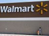 File photo of people walking past a Wal-Mart sign in Rogers, Arkansas