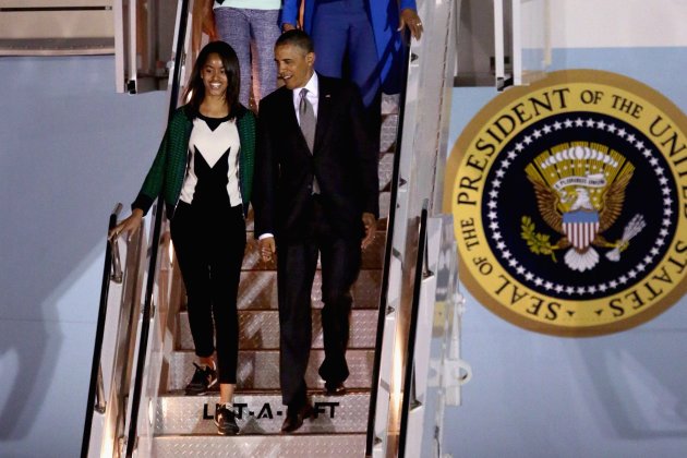 PRETORIA, SOUTH AFRICA - JUNE 28: U.S. President Barack Obama (R) and his daughter Malia Obama arrive at Waterkloof Air Force Base June 28, 2013 in Pretoria, South Africa. This is Obama's first official visit to South Africa, where is schedule to hold bilaterial meetings with President Jacob Zuma, host a town hall meeting with students in Soweto Township and visit Robben Island, where former President Nelson Mandela spent some of his 27 years in prison for fighting against apartheid. (Photo by Chip Somodevilla/Getty Images)