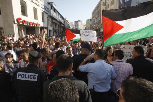 Palestinian protesters rally in front of Palestinian President Abbas' security forces as they tried to march on headquarters in protest against meeting between Abbas and Israeli VP Mofaz, even though it had been put off, in Ramallah