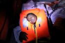 Mata, 23, from Nigeria, tries to recover after fainting during a rescue operation of 104 sub-Saharan migrants aboard a raft by the Spanish NGO Proactiva Open Arms, in the central Mediterranean Sea, 24 miles north of the coastal Libyan city of Sabratha