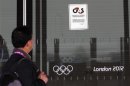 A visitor to the Olympic Park reads a 4GS notice stuck to a window at the Aquatics centre, in the Olympic Park, in Stratford
