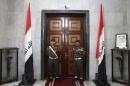 Iraqi guards stand in front of a door inside the Ministry of Defence during a visit from U.S. Secretary of Defense Hagel, in Baghdad