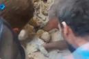 A still image from video posted on social media web sites September 23, 2016 shows a baby being rescued from rubble of a collapsed building in Aleppo