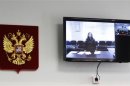 Jailed Pussy Riot punk rock group member Alyokhina is seen on a monitor inside the courtroom during a hearing in Berezniki