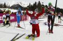 Switzerland's Dario Cologna, center, celebrates winning the the men's cross-country 30k skiathlon as, from left, Germany's Tobias Angerer, Italy's Giorgio di Centa and Norway's Petter Northug look at the 2014 Winter Olympics, Sunday, Feb. 9, 2014, in Krasnaya Polyana, Russia. (AP Photo/Gregorio Borgia)