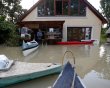 Peter Cziraki stands in flood water surrounding his house in Nagymaros