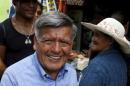 Peruvian presidential candidate Cesar Acuna greets supporters during a rally at a market in Brena district of Lima