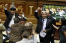 MUD deputies Ygarza, Guarulla and Guzamana celebrate after their swearing-in ceremony during a session of the National Assembly in Caracas