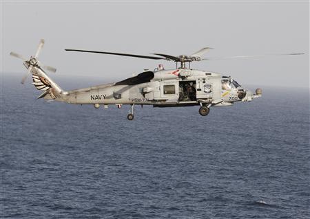 File photo of a Sikorsky SH-60 Seahawk helicopter flies near the Nimitz-class aircraft carrier USS Abraham Lincoln (CVN 72) during a transit through the Strait of Hormuz