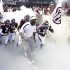 Texas A&M coach Kevin Sumlin, center, leads his team out onto the field before an NCAA college football game against Florida, Saturday, Sept. 8, 2012, in College Station, Texas. Texas A&M begins a new era with its first Southeastern Conference game after leaving the Big 12 Conference. (AP Photo/David J. Phillip)