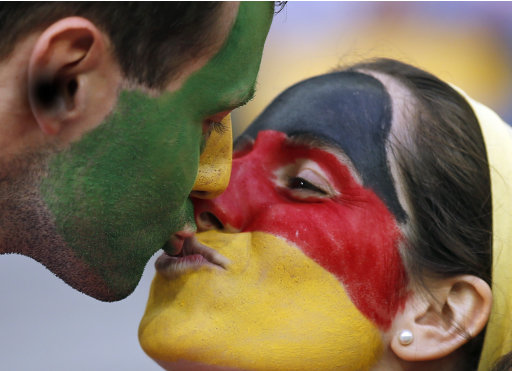 German fans kiss before the Euro 2012 soccer championship Group B match between Germany and Portugal in Lviv, Ukraine, Saturday, June 9, 2012. (AP Photo/Armando Franca)