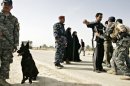 Iraqi police commandos frisk Iraqis in Baquba, in 2010
