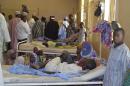 Residents, who were injured during an attack by Boko Haram militants, wait at the Bama General Hospital in Bama