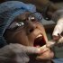 A dentist checks the teeth of a U.S. patient, at a dental clinic in San Jose