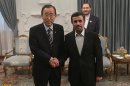 United Nations Secretary-General Ban Ki-moon poses for a photo with Iran's President Ahmadinejad upon his arrival for 16th summit of Non-Aligned Movement in Tehran