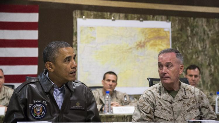 President Barack Obama, left, speaks during a briefing by Marine General Joseph Dunford, commander of the US-led International Security Assistance Force (ISAF), after arriving at Bagram Air Field for an unannounced visit, on Sunday, May 25, 2014, north of Kabul, Afghanistan. (AP Photo/ Evan Vucci)