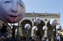 Activists of the international campaigning and advocacy organization ONE installed balloons with portraits of the G-7 heads of state in Munich, Germany, Friday, June 5, 2015. (AP Photo/Matthias Schrader)