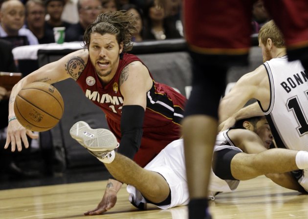 Miami Heat shooting guard Mike Miller, San Antonio Spurs point guard Cory Joseph and Matt Bonner, right, battle for a loose ball during the first half at Game 3 of the NBA Finals basketball series, Tuesday, June 11, 2013, in San Antonio. (AP Photo/Eric Gay)