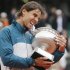 Nadal of Spain bites the trophy after defeating compatriot Ferrer in their men's singles final match to win the French Open tennis tournament in Paris