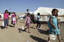 Syrian refugee children play outside a tent during the first day of the Muslim festival of Eid-al-Adha at the Arbat refugee camp in the northern Iraqi province of Sulaimaniya