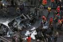 Lebanese security forces and firefighters at the scene of a huge car bomb in Beirut on December 27, 2013