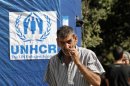 A Syrian refugee smokes during the visit of U.N. High Commissioner for Refugees (UNHCR) Antonio Guterres in Ketermaya village in the Chouf mountains