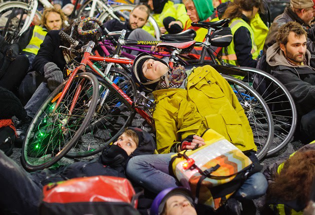 Cyclists take part in a 'die-in' protest outside the headquarters of Transport for London, in Blackfriars, London, calling for action to improve safety