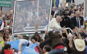 Pope Francis waves to the crowd as he rides aboard &hellip;