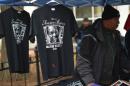 Vendors stand next to t-shirts bearing the image of former Washington Mayor Marion Barry at the Washington Convention Center during his memorial service on December 6, 2014