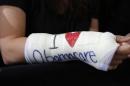 Park of Cambridge wears cast for her broken wrist with "I Love Obamacare" written upon it prior to U.S. President Barack Obama's arrival to speak about health insurance at Faneuil Hall in Boston