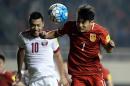 Wu Lei (R) of China competes for the ball with Rodrigo Tabata of Qatar during their 2018 World Cup football qualifying match on March 29, 2016