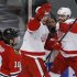 Red Wings' Smith celebrates his goal with teammate Zetterberg as Blackhawks' Sharp skates past during Game 2 of their NHL Western Conference semi-final playoff hockey game in Chicago