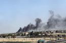 Smoke billows from the site of a car explosion in Baghdad's northern Shiite-majority district of Sadr City, May 13, 2014