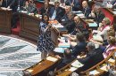 Cecile Duflot, the Housing minister, speaks before France's National Assembly in Paris, Tuesday, July 17, 2012 in this frame made from TV. The hooting and catcalls began as soon as the Cabinet minister stood, wearing a blue and white flowered dress. It did not cease for the entire time she spoke before France's National Assembly and the heckling came not from an unruly crowd, but from male legislators who later said they were merely showing their appreciation on a warm summer's day. Duflot faltered very slightly, and then continued with her prepared remarks about an urban development project in Paris. "Ladies and gentlemen, but mostly gentlemen, obviously," she said in a firm voice as hoots rang out. She completed the statement on her ministry and again sat down. None of the men in suits who preceded her got the same treatment from the deputies, and the reaction was extraordinary enough to draw television commentary and headlines for days afterward. (AP Photo / National Assembly TV) TV OUT