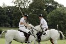 Britain's Duke of Cambridge, Prince William, left, and Prince Harry during the Audi Polo Challenge charity polo match, at Coworth Park, near Ascot, England, Saturday Aug. 3, 2013. Prince William has made his first public appearance since leaving hospital with his newborn son, playing in a charity polo match alongside brother Prince Harry. (AP Photo / Jane Mingay)