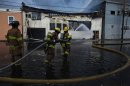 New Jersey firefighters spray water as they work to control a fire in Seaside Park in New Jersey