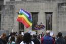 Supporters of same-sex marriage hold a rainbow flag and a rainbow umbrella outside Jefferson County Courthouse in Birmingham