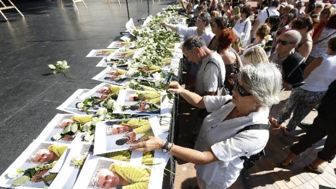 People pay tribute to mountain-guide Herve Gourdel, who was beheaded by Jihadists linked to the Islamic State group in Algeria, during a gathering in Nice, southeastern France, on September 27, 2014
