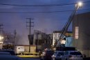 Emergency crews are shown outside Neptune Technologies in Sherbrooke, Que., Thursday, November 8, 2012 where a large explosion at the plant sent a number of people to hospital with serious injuries. THE CANADIAN PRESS/Graham Hughes.