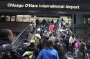 Crowds of travelers leave the subway at the Chicago's O'Hare International Airport