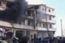 In this image taken from video obtained from the Shaam News Network, which has been authenticated based on its contents and other AP reporting, smoke billows from a building after a blast in Aleppo, Syria, Thursday, Dec. 19, 2013. In northern Syria, government war planes have bombed rebel-held districts of Aleppo for the fifth straight day, leveling apartment buildings, flooding hospitals with casualties in attacks that have so far killed nearly 200 people, activists said. (AP Photo/Shaam News Network via AP Video)